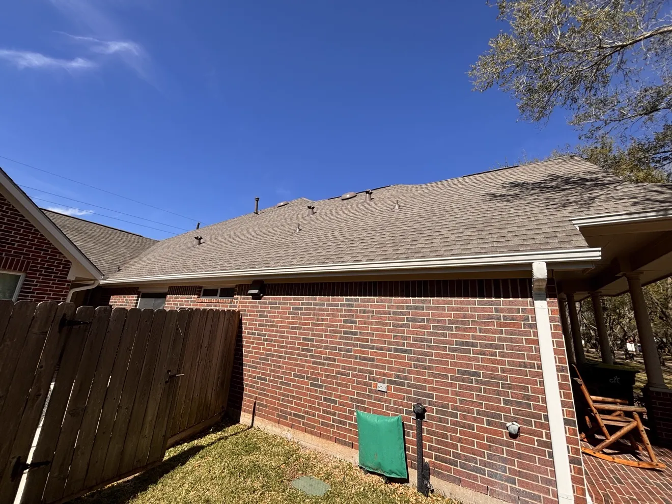 Brick home with a newly replaced shingle roof