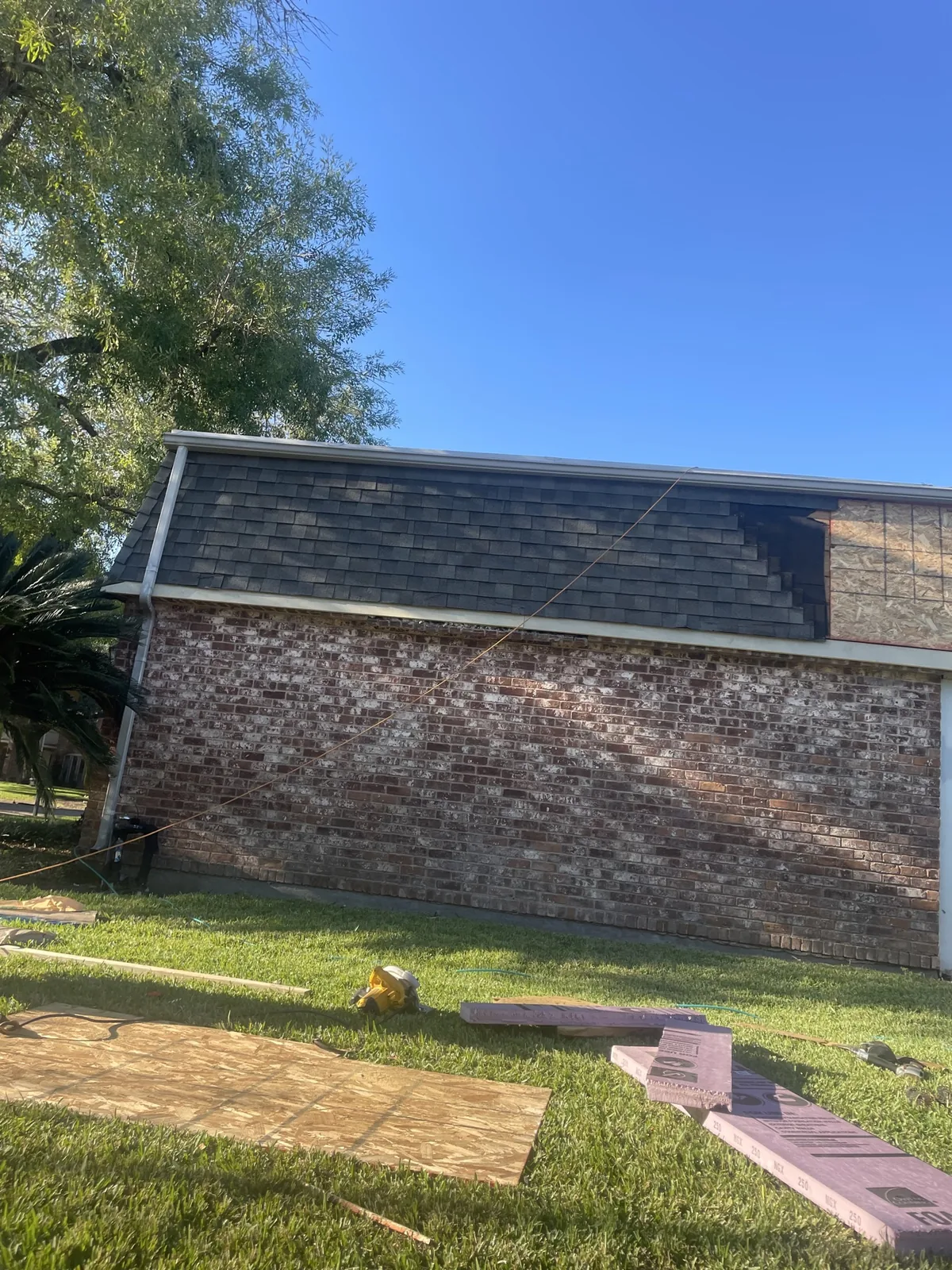 New shingles installed over repaired roof section