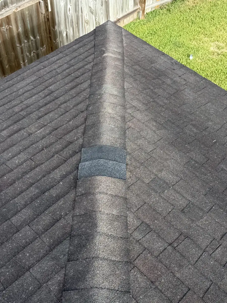 Repaired ridge caps on an asphalt shingle roof