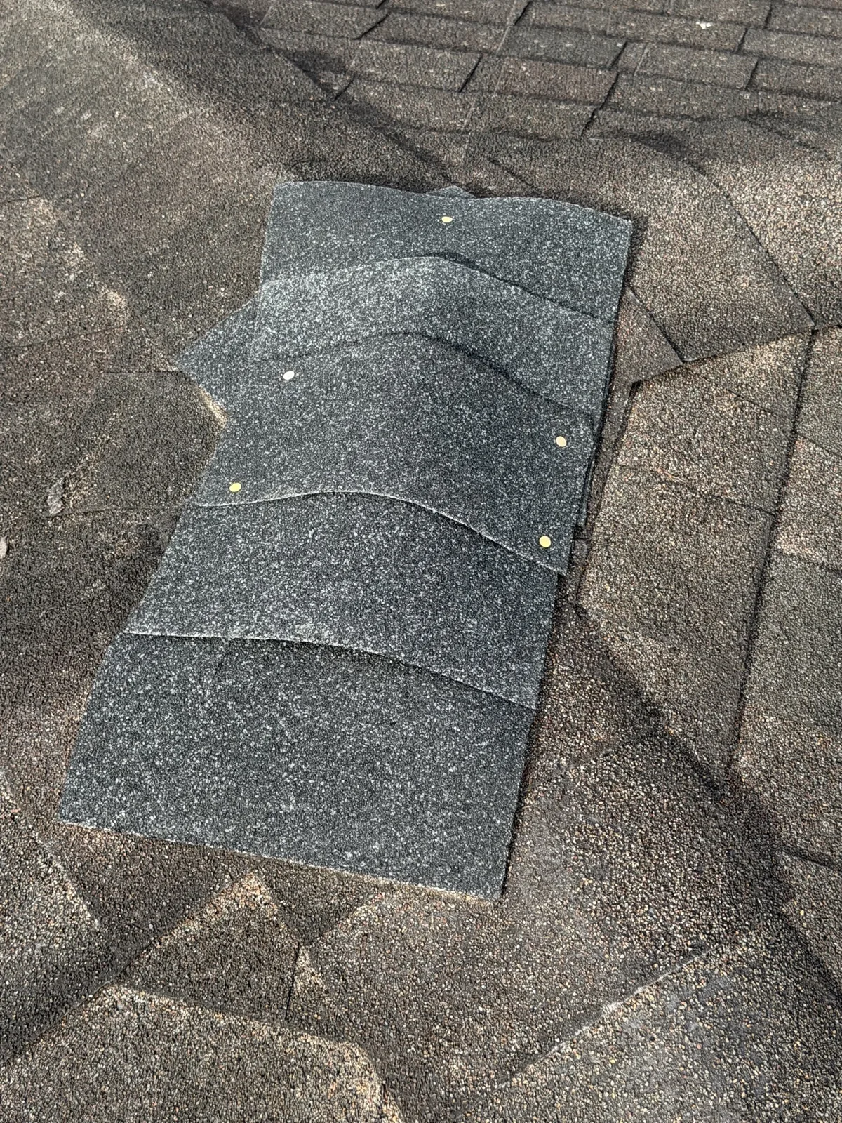 Close-up of architectural shingles on a repaired residential roof