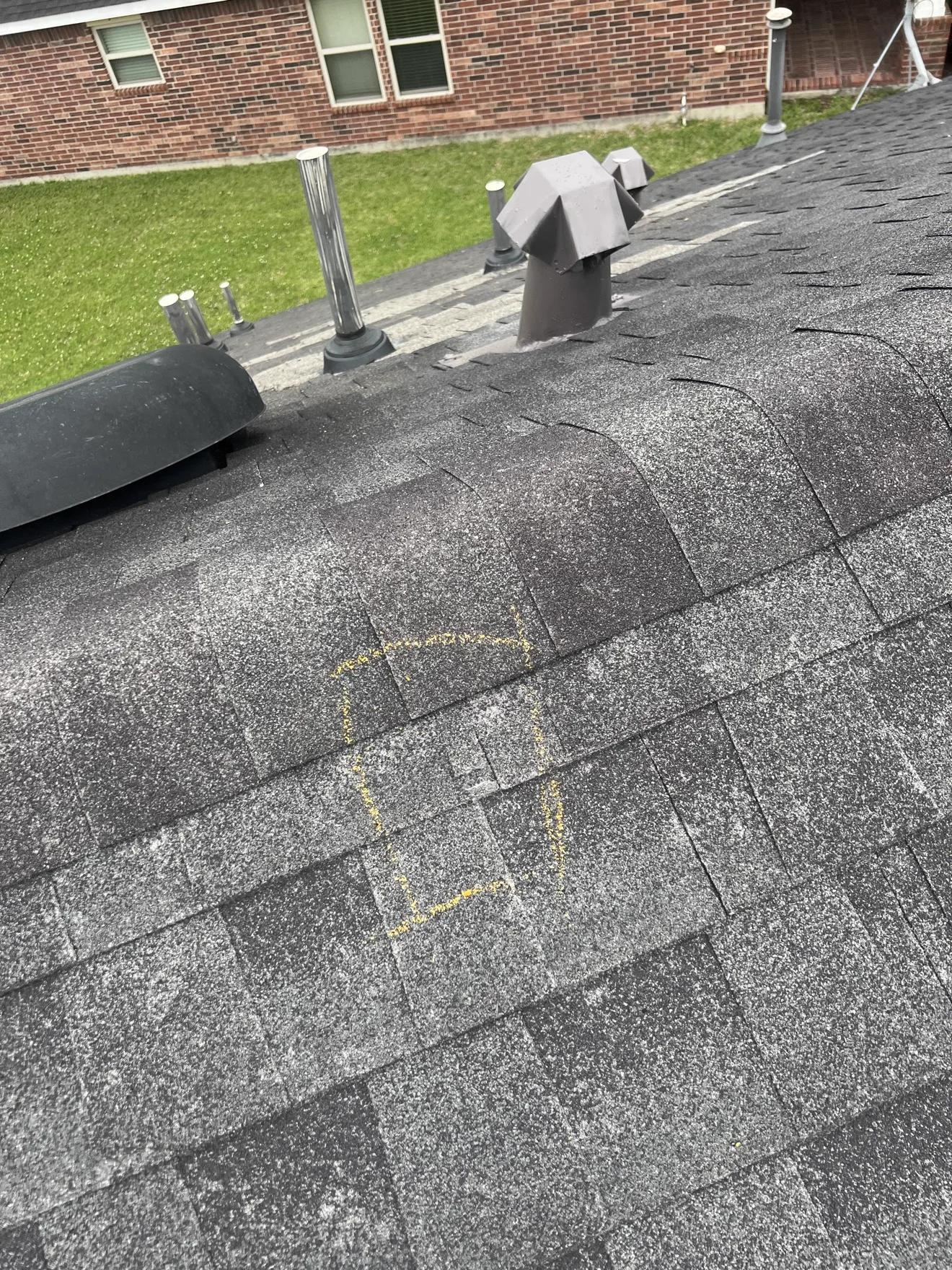 Chalk-marked hail damage on asphalt shingles